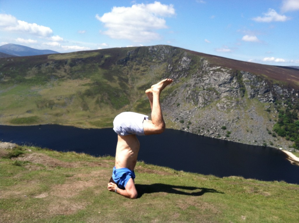 Getting up into headstand yoga asana in wicklow mountains ireland glendalough backpacking hostel